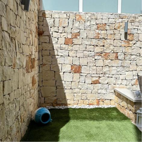 a room with a brick wall and a blue ball at SUITE CALA PAURA in Polignano a Mare