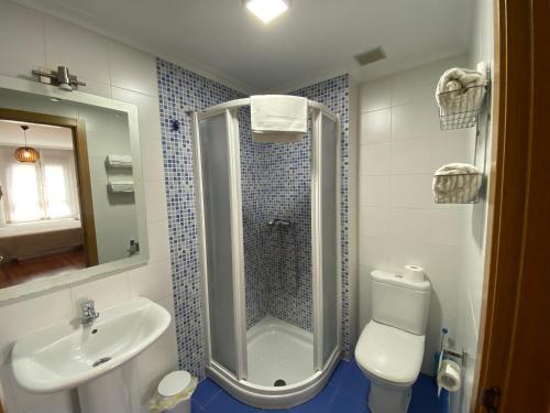 a bathroom with a shower and a toilet and a sink at dpCristal LikeHome in Sarria
