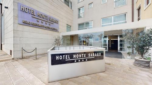 a hotel sign in front of a building at Hotel Monte Sarago in Ostuni