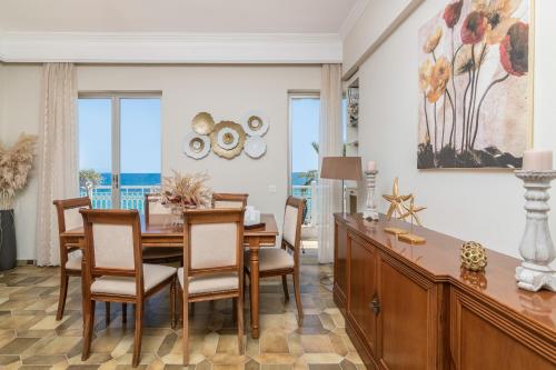 a dining room with a table and chairs at Mare Nostrum Seafront Apartment in Zakynthos Town