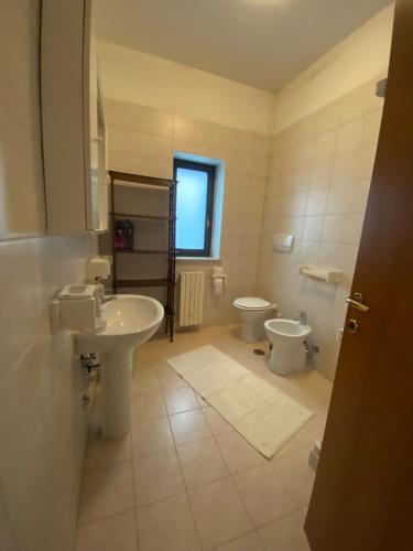 a bathroom with a sink and a toilet and a window at Agriturismo Masseria Pastore in Martina Franca