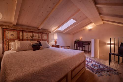 Schlafzimmer mit einem großen Bett und einem Dachfenster in der Unterkunft "La Casa dei Gelsi" - Panorama Lodge by Stay Generous in Scudellate