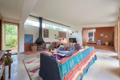 a living room with a couch and a fireplace at Quinta TreeWindBee in Alenquer