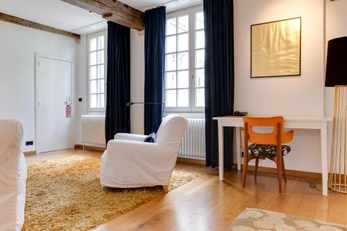 a living room with two chairs and a desk at Hotel De Witte Lelie -Small Luxury Hotels of the World in Antwerp