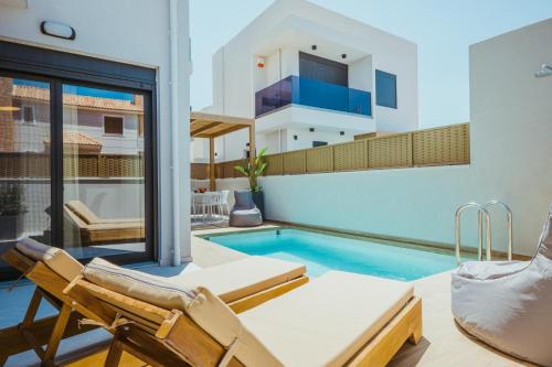 a villa with a swimming pool and a house at Anemmaro Villa 1 in Crete in Gournes