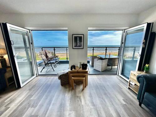 a living room with a view of the ocean at South Beach Villa in Bridlington