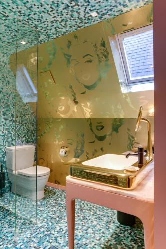 a bathroom with a sink and a toilet at Hotel De Witte Lelie -Small Luxury Hotels of the World in Antwerp