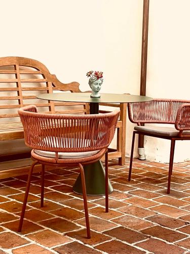 a table with two chairs and a vase on it at Renaissancehof Wieser Wachau in Wösendorf