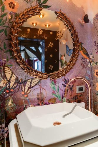 a bathroom with a white sink and a mirror at Hotel De Witte Lelie -Small Luxury Hotels of the World in Antwerp