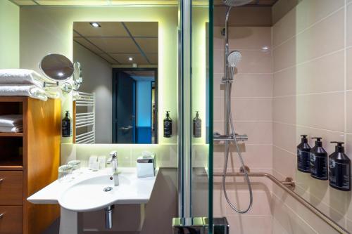 a bathroom with a sink and a shower at Le Splendid Hotel Lac D'Annecy - Handwritten Collection in Annecy