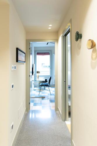 a hallway with a chair and a desk at Palazzo Scappi Gardi Luxury Apartments in Bologna