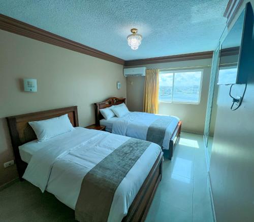 Ένα ή περισσότερα κρεβάτια σε δωμάτιο στο Apart Hotel Hamilton
