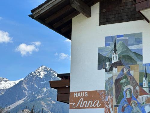 a mural on the side of a building with mountains in the background at Haus Anna in Fischen