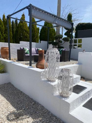 two glass vases sitting on top of a white wall at Cuevas Helena in Benamaurel