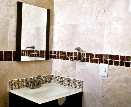 a bathroom with a sink and a mirror at Hotel Punta Esmeralda in Playa del Carmen