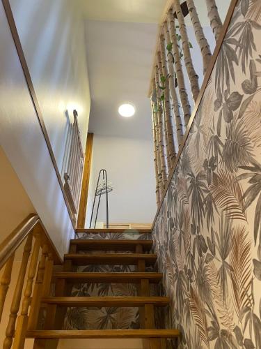 a staircase in a house with a mural on the wall at Agroturystyka Sosnowy Gaik in Tykocin
