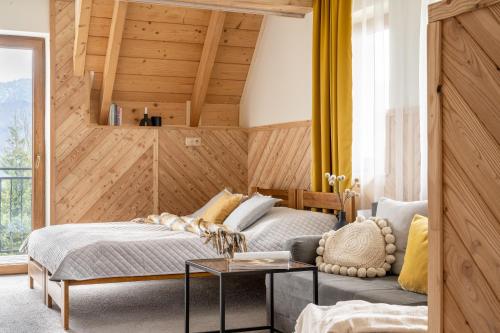 a bedroom with a bed and a table at Villa Tatrica in Kościelisko