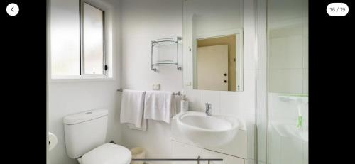 a bathroom with a sink and a toilet and a mirror at Guest ensuite 7 minutes from airport in Melbourne