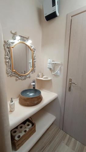 a bathroom with a sink and a mirror at Enigma Boutique Houses Koxyli in Marmarion