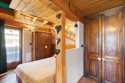 a bedroom with a bed and wooden walls at La Casetta di La Thuile in La Thuile