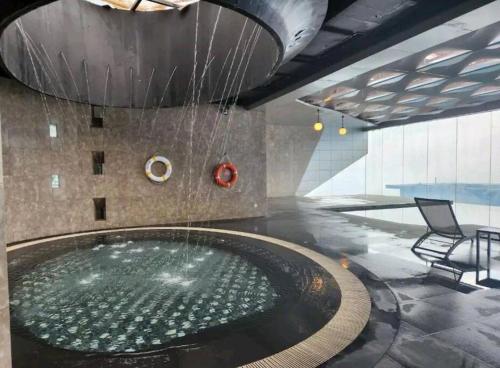 a hot tub in a building with a fountain at Genting Highlands Peak 8paxCozyHome at Ion Delemen in Genting Highlands