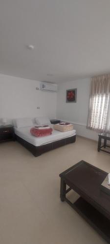 a room with two beds and a table in it at Al Namteh Lodge in ‘Ābil