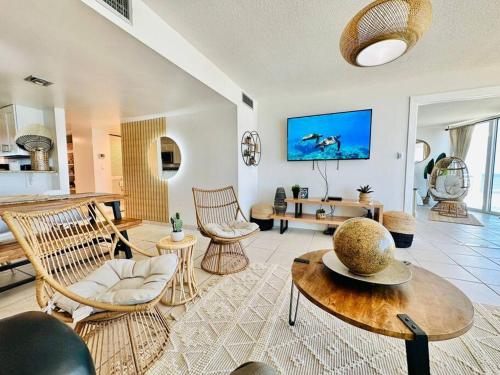 a living room with chairs and a table at Relax and Retreat at BellaView603 - Comfortable Oceanfront Condo in Daytona Beach