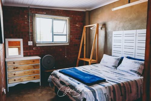 מיטה או מיטות בחדר ב-Oppi Plaas See Uitsig