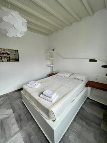a white bedroom with a large white bed in it at Sonia in Mikonos