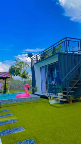 a house with a pool and a pink slide at ADRIANA CABIN in Melaka