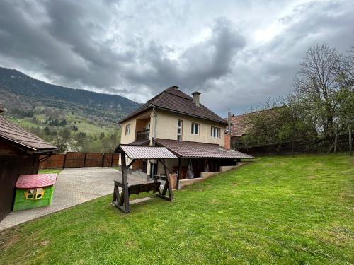 a house with a picnic table in the yard at Casa Vidra in Vidra