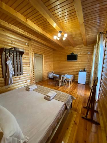 a bedroom with a large bed in a wooden room at Dachna Sadyba PB in Migovo