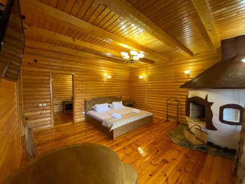 a large bedroom with a bed and a fireplace at Dachna Sadyba PB in Migovo