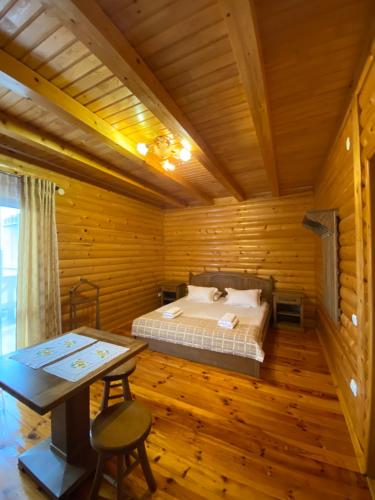 a bedroom with a bed in a wooden room at Dachna Sadyba PB in Migovo