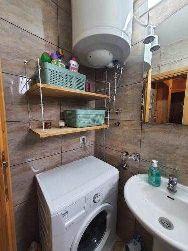 a bathroom with a washing machine and a sink at Vacation Home Andjelic in Žabljak