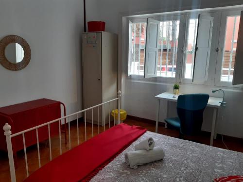 a bedroom with a bed and a table and a desk at Nomad Villa Santa Fe in Las Palmas de Gran Canaria