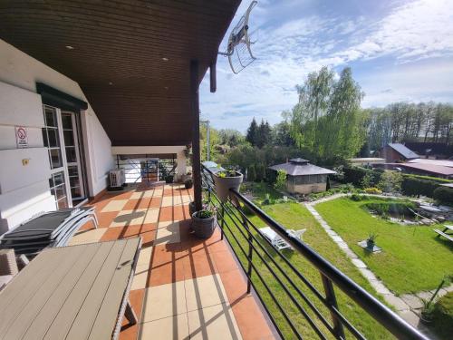 a balcony of a house with a view of a yard at Willa Rudnik in Grudziądz