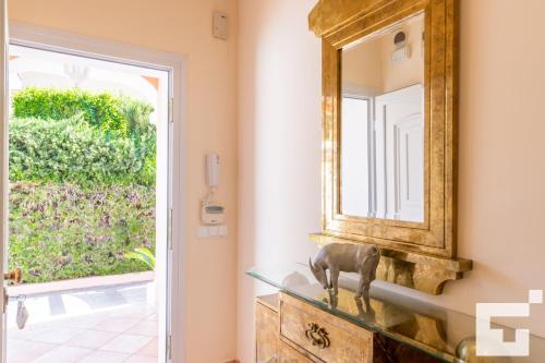 un espejo en una pared al lado de una puerta en Villa Coral - Grupo Turis, en Calpe