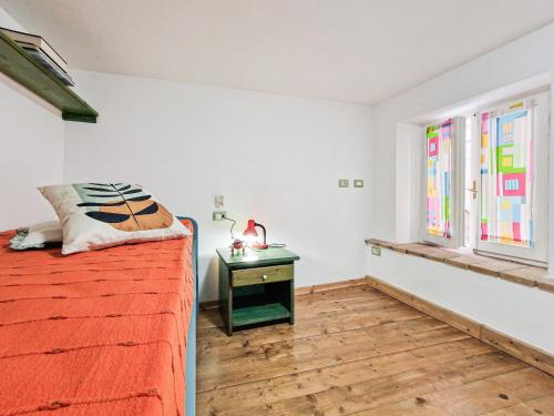 a bedroom with a bed and a table with a lamp at Il Borgo 4 in Capoliveri