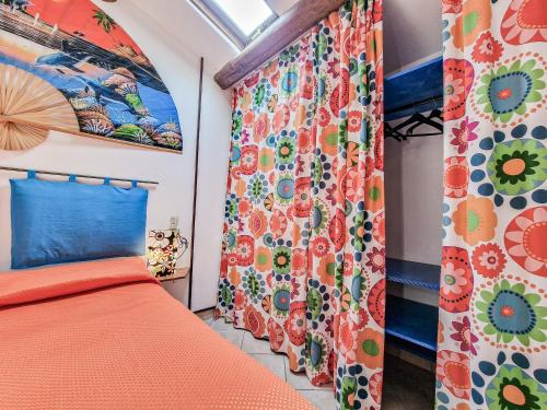a bedroom with an orange bed and a window at Il Borgo 4 in Capoliveri