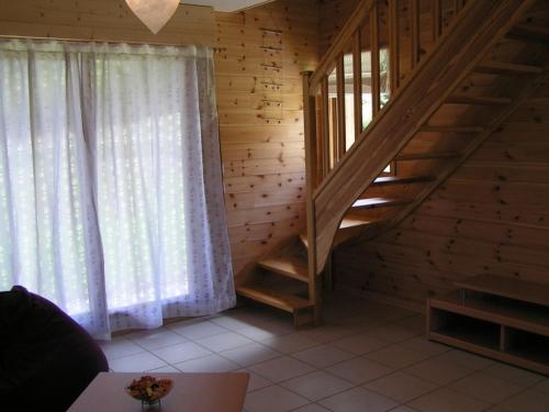 une chambre avec un escalier dans une maison en bois dans l'établissement Les Chalets du Choumeau, à Saint-Léger-les-Mélèzes