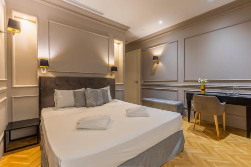 a bedroom with a large bed and a desk at Belle Boutique in Sliema