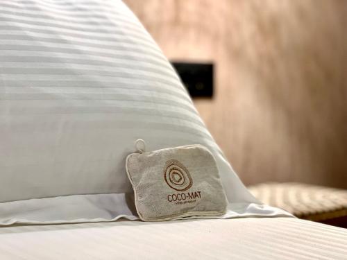 a pillow sitting on top of a bed at Psamathi Living & Taste in Marathi