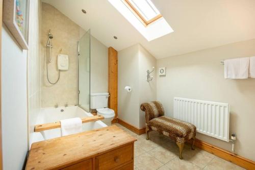 a bathroom with a tub and a toilet and a sink at The Shed in Durham