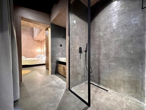 a bathroom with a shower with a glass door at Psamathi Living & Taste in Marathi