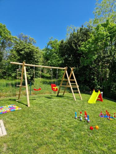 a playground with a swing and toys on the grass at Villa Destiny Nedescina, Istrien, Kroatien in Nedeščina