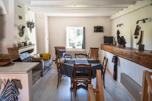 a living room with a table and a couch at Josette in Asquins