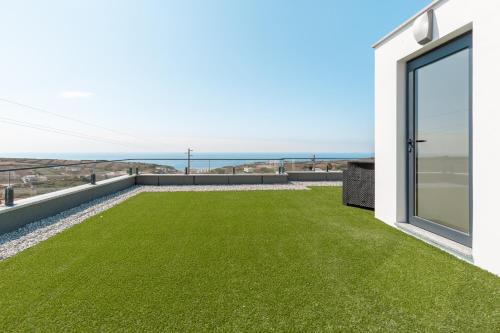 a garden with green grass on the roof of a house at Dream Villa with ocean view in Lourinhã