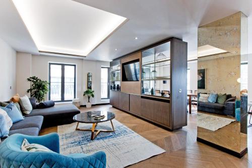 a living room with a couch and a table at 37GS Residences in London