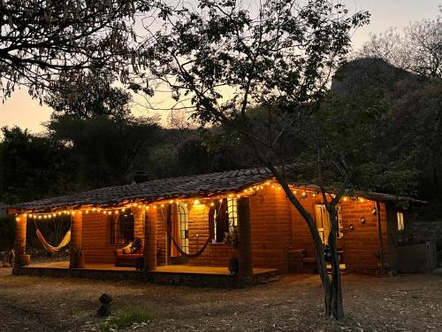 a small wooden cabin with lights on it at Cabaña en Malinalco Zarla in Malinalco